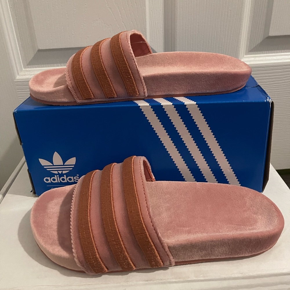 Pink adidas slides.